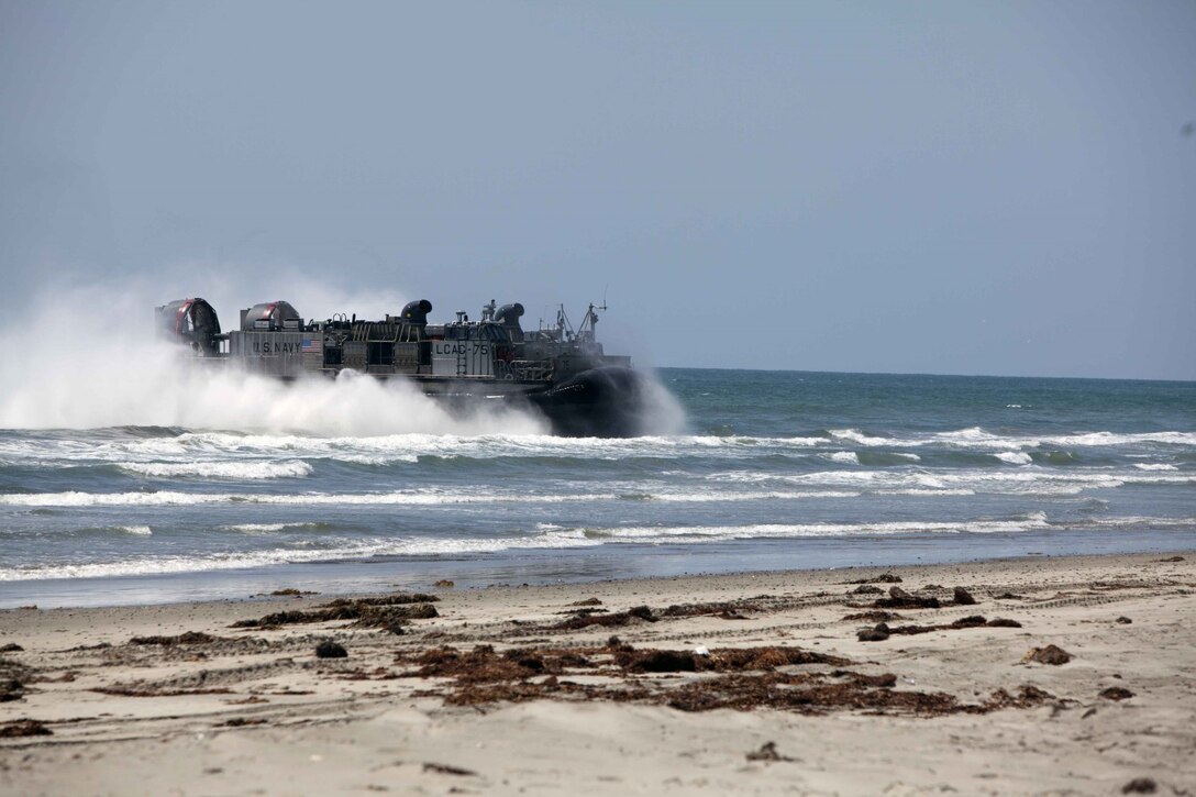 A landing craft air cushion (LCAC) lands on Red Beach after launching from the USS Makin Island during Composite Training Unit Exercise (COMPTUEX) off the coast of San Diego, May 8, 2014. COMPTUEX serves as the second at-sea period for the 11th MEU, in which the unit will focus on the enabling and supporting functions necessary for success during full mission profiles operations during the upcoming deployment. (U.S. Marine Corps photo by Cpl. Jonathan R. Waldman/Released)