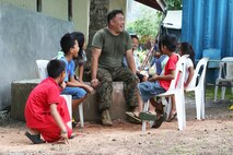 U.S. Navy Petty Officer 2nd Class Lee Halls, a corpsman with 9th Engineer Support Battalion, interacts with locals during exercise Balikatan 2014 in Guinobatan, Philippines, April 22, 2014. The project is one of five engineering civic action program missions by Joint Civil Military Operations Task Force units in support of BK14. This year marks the 30th iteration of the exercise, which is an annual Republic of the Philippines-U.S. military bilateral training exercise and humanitarian civic assistance engagement. (U.S. Marine Corps photo by Lance Cpl. Trever Statz/)