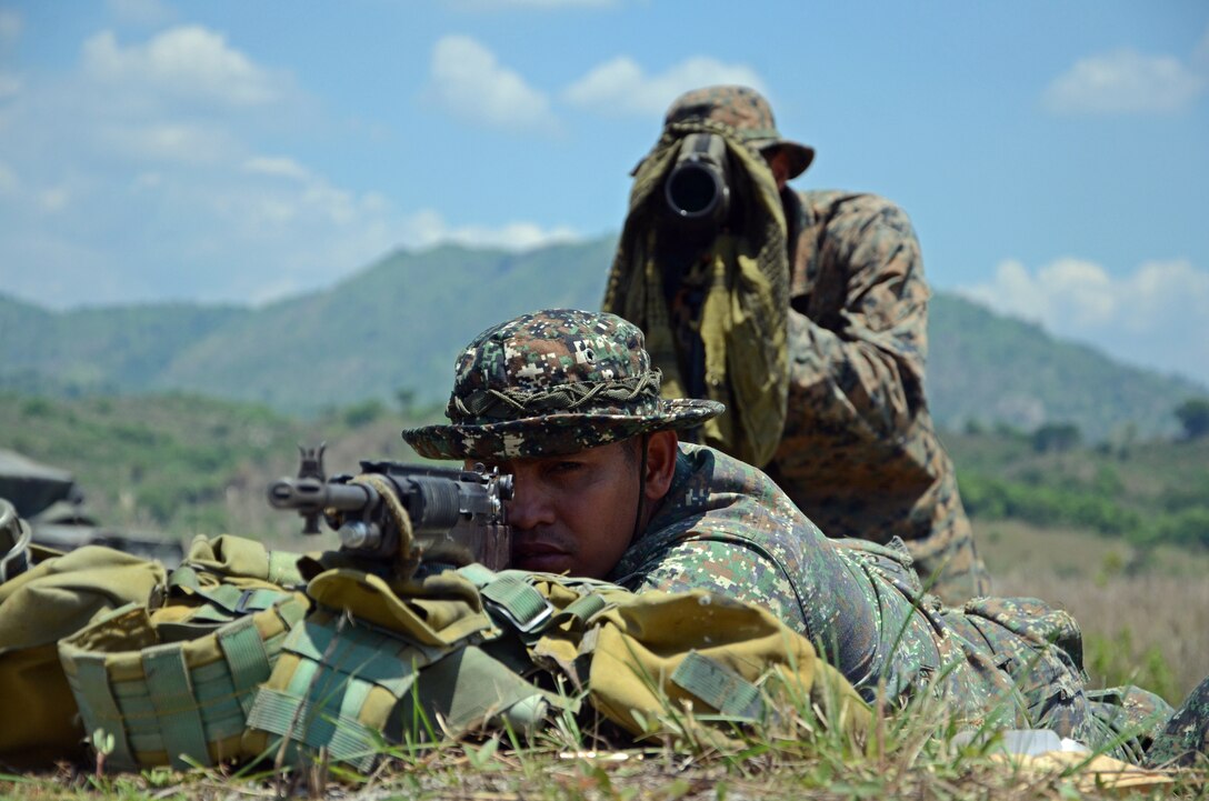 A U.S. Marine sniper spots his Philippine Marine counterpart while he takes aim during a live-fire sniper training exercise at Crow Valley, Philippines, on May 8, 2014, during Balikatan 2014. Balikatan is an annual training exercise that strengthens the interoperability between the armed forces of the Philippines and U.S. military in their commitment to regional security and stability, humanitarian assistance and disaster relief. (U.S. Army photo by Spc. Matthew Sissel/Released)
