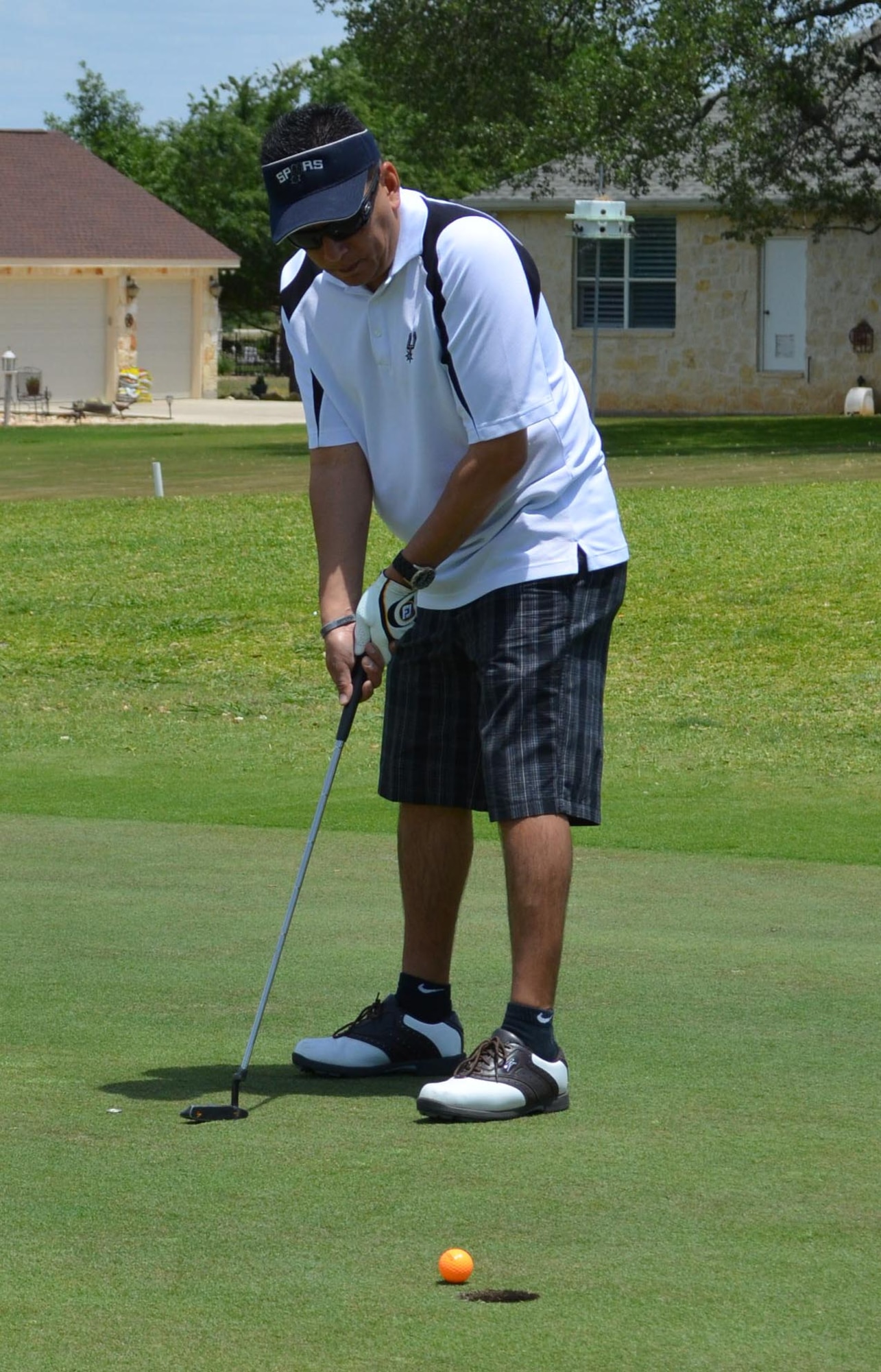 Master Sgt. Max Hernandez, 433rd Maintenance Squadron, waits to see his put fall in to cup during the second annual MXG Golf Tournament held May 2 at the Alsatian Golf Club in Castroville, Texas. The tournament raised $1,700 for the Morale and Welfare Fund. (U.S. Air Force Photo/ Maj. Tim Wade)