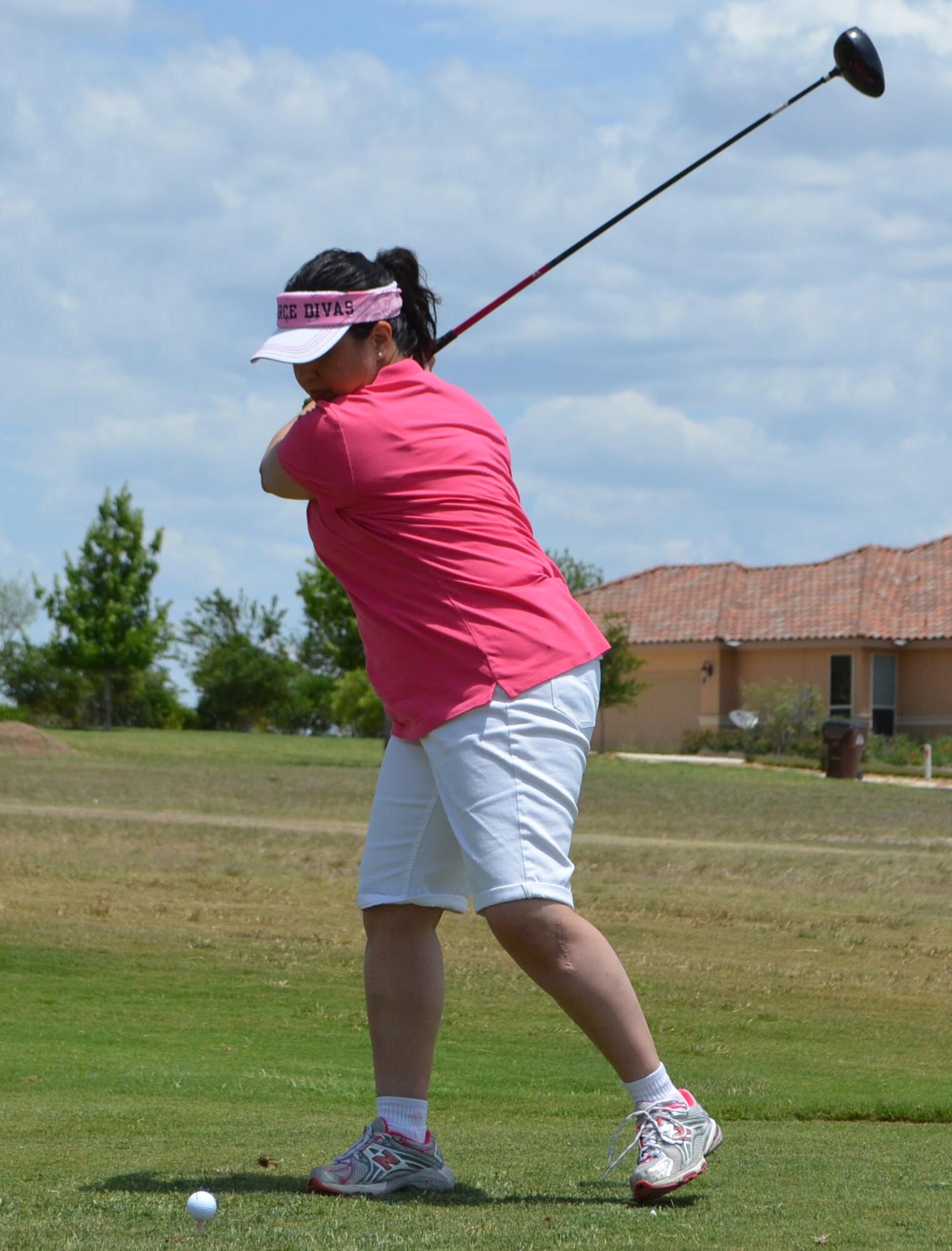 Tech. Sgt. Julia Sandoval, 433rd Medical Group, prepares to strike the ball during the second annual MXG Golf Tournament held May 2 at the Alsatian Golf Club in Castroville, Texas. Sandoval was a member of one of the two ladies' team in the field. (U.S. Air Force Photo/ Maj. Tim Wade)