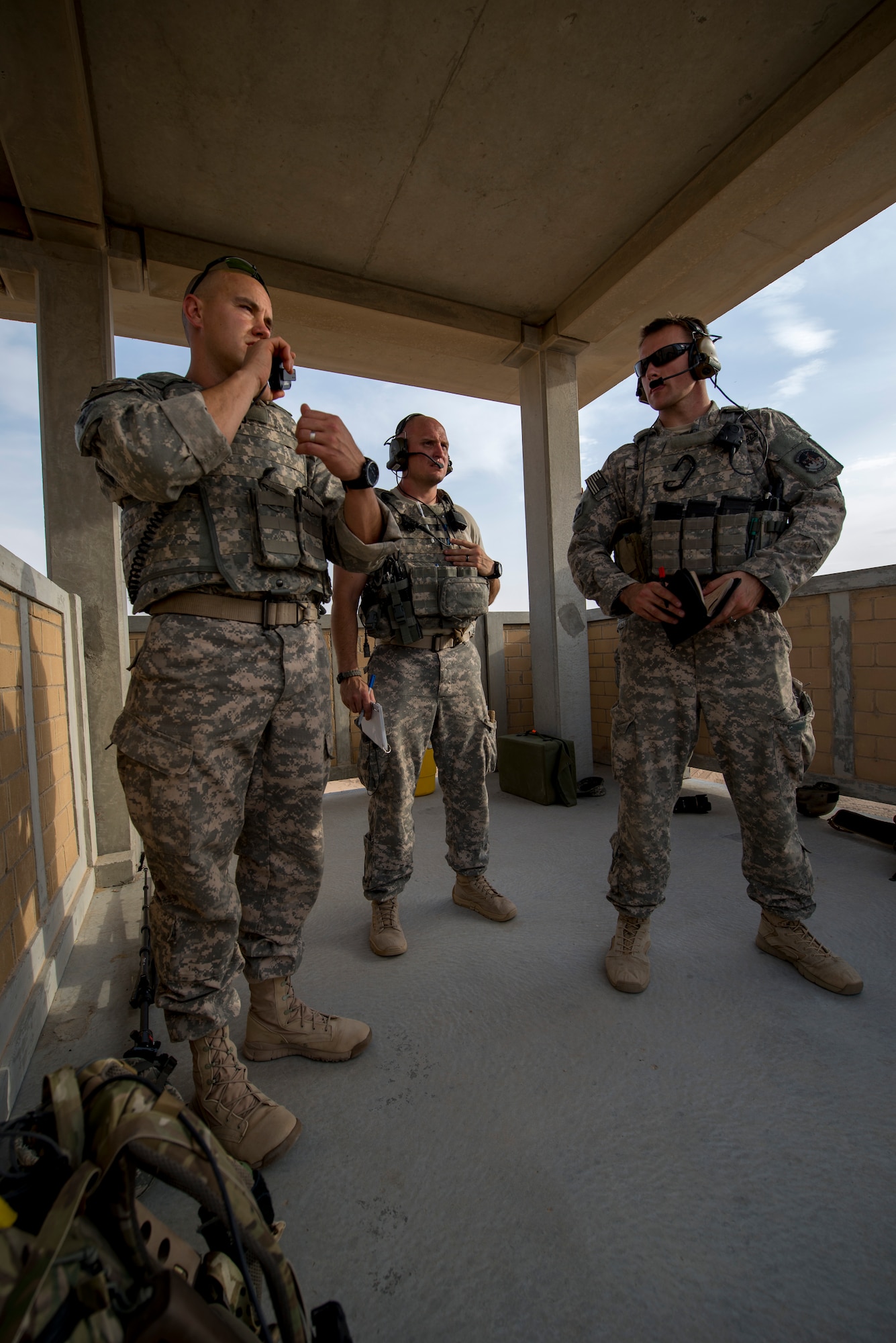 U.S. Air Force Staff Sgt. Jacob Noojin (left) and Senior Airmen Daniel Wolcott (center) and Michael Bradley (right) coordinate air support during a Joint Operations live fire exercise on May 7, 2014 at an undisclosed location in Southwest Asia. TACPs are composed of Joint Terminal Attack Controllers who provide terminal attack control and fire support expertise for all U. S. Army and U.S. Navy Special Forces and special missions units. (U.S. Air Force photo by Staff Sgt. Jeremy Bowcock))