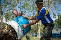 Philippine Air Force Staff Sgt. Ruperto S. Pido, carpenter, with 6021st Career Executive Service, Clark Air Base, Mabalacat, and U.S. Marine Corps Lance Cpl. Drew T. Cohen, a Chemical, Biological, Radiological, and Nuclear defense specialist with Combat Logistics Regiment 37, 3rd Marine Logistics Group, stationed at Camp Kinser, Okinawa, Japan, work together during a community relations project during Balikatan 2014 at Air Force City High School, Mabalacat, Republic of the Philippines, May 9, 2014. This year marks the 30th iteration of Balikatan, which is an annual Republic of the Philippines-U.S. military bilateral training exercise. (U.S. Marine Corps photo by Lance Cpl. Allison DeVries/Released)