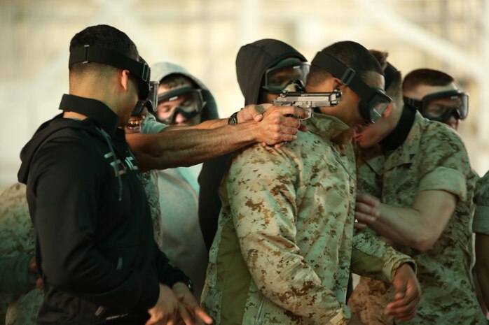 Marines with the Provost Marshal’s Office aboard Marine Corps Air Station Iwakuni, Japan, conduct a scenario during the Advanced Active Shooter course April 7 - 18, 2014. During the scenarios, Marines used airsoft pistols to create adrenaline needed for training.