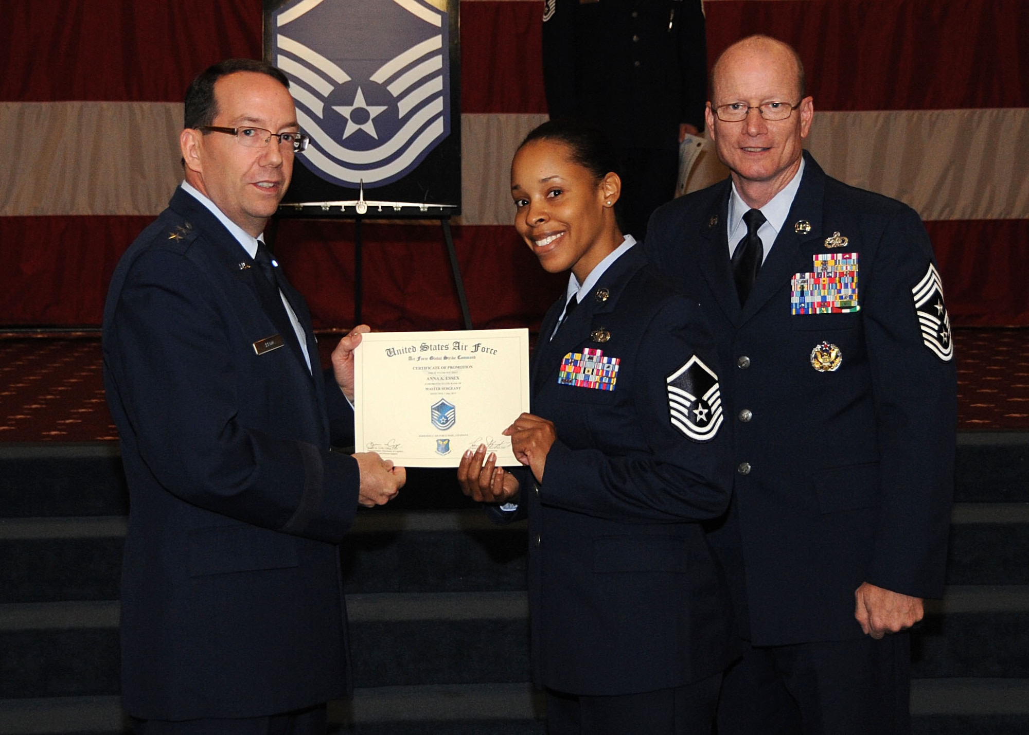 Master Sgt. Ana Essex, Air Force Global Strike Command, receives a certificate of promotion from Maj. Gen. Robert Rego, AFGSC vice commander, and Chief Master Sgt. Terry West, AFGSC command chief, during the Wing Promotion Ceremony on Barksdale Air Force Base, La., April 30, 2014. (U.S. Air Force photo/Senior Airman Kristin High)