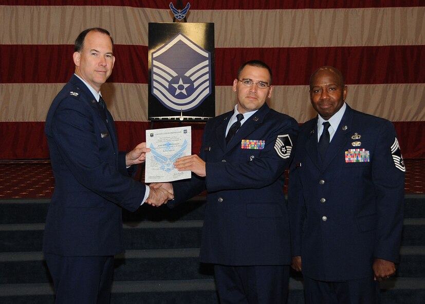 Master Sgt. Jeremy Davidson, 8th Air Force, receives a certificate of promotion from Col. Russell Mathers, 8th Air Force vice commander, and Chief Master Sgt. Jeffery Smith, 608th Air Operations Center command chief, during the Wing Promotion Ceremony on Barksdale Air Force Base, La., April 30, 2014. (U.S. Air Force photo/Senior Airman Kristin High)
