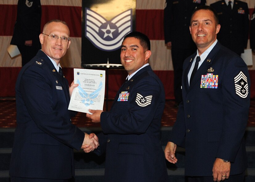 Tech. Sgt. Charles Coy, 2nd Maintenance Squadron, receives a certificate of promotion from Col. Michael Adderley, 2nd Operations Group commander, and Chief Master Sgt. Curtis Storms, 2nd Bomb Wing command chief, during the Wing Promotion Ceremony on Barksdale Air Force Base, La., April 30, 2014. (U.S. Air Force photo/Senior Airman Kristin High)