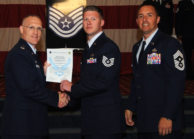 Tech. Sgt. Andrew Walton, 2nd Maintenance Group, receives a certificate of promotion from Col. Michael Adderley, 2nd Operations Group commander, and Chief Master Sgt. Curtis Storms, 2nd Bomb Wing command chief, during the Wing Promotion Ceremony on Barksdale Air Force Base, La., April 30, 2014. (U.S. Air Force photo/Senior Airman Kristin High)