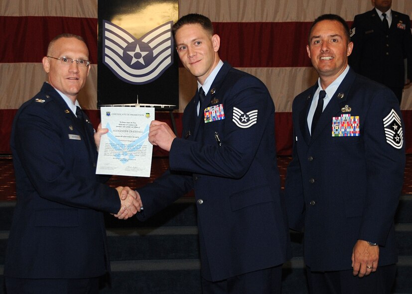 Tech. Sgt. Alexander Crandall, 2nd Maintenance Group, receives a certificate of promotion from Col. Michael Adderley, 2nd Operations Group commander, and Chief Master Sgt. Curtis Storms, 2nd Bomb Wing command chief, during the Wing Promotion Ceremony on Barksdale Air Force Base, La., April 30, 2014. (U.S. Air Force photo/Senior Airman Kristin High)