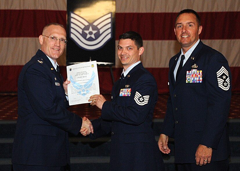 Tech. Sgt. Craig Reed, 2nd Bomb Wing, receives a certificate of promotion from Col. Michael Adderley, 2nd Operations Group commander, and Chief Master Sgt. Curtis Storms, 2nd Bomb Wing command chief, during the Wing Promotion Ceremony on Barksdale Air Force Base, La., April 30, 2014. (U.S. Air Force photo/Senior Airman Kristin High)