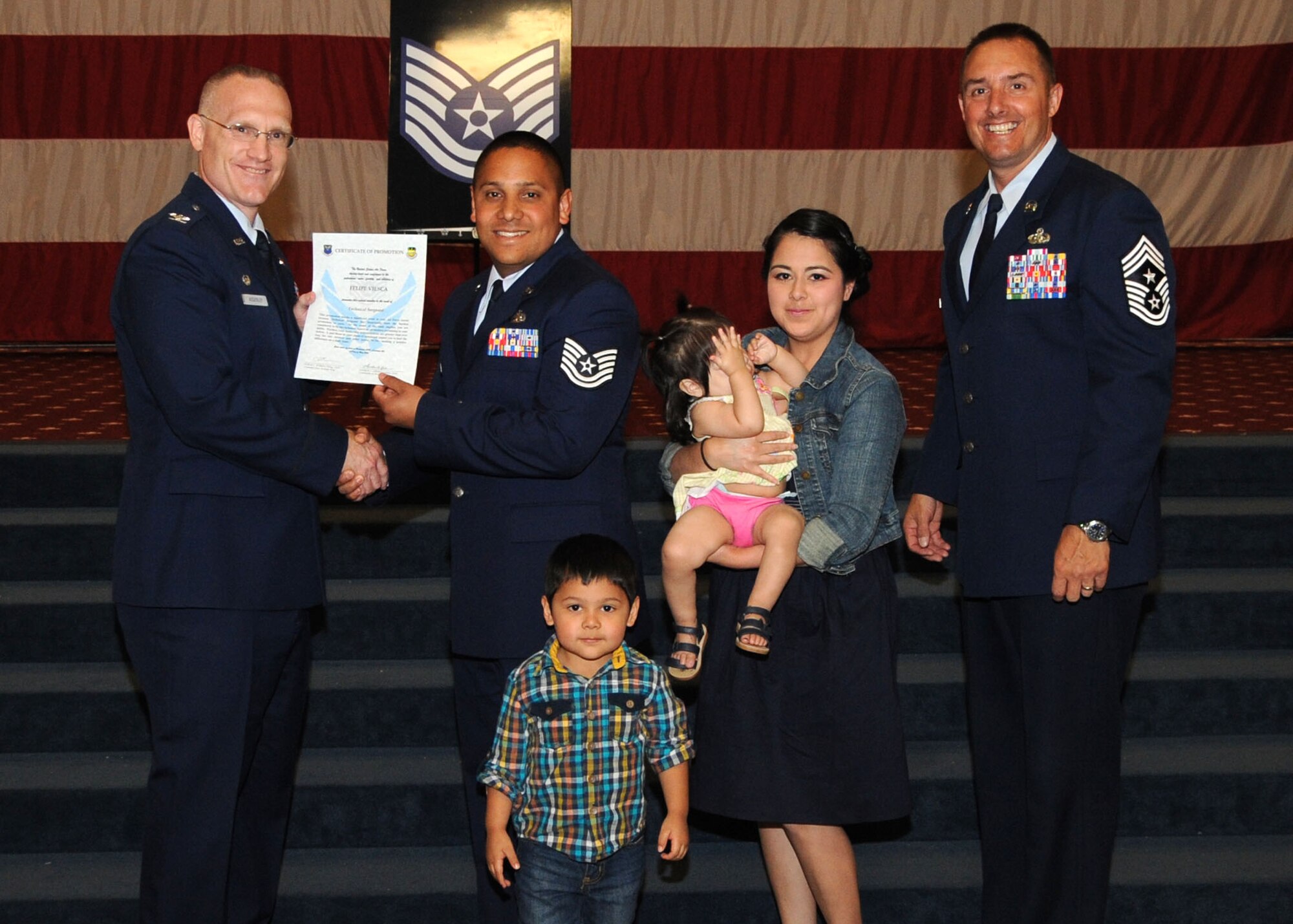 Tech. Sgt. Felipe Viesca, 2nd Aircraft Maintenance Squadron, receives a certificate of promotion from Col. Michael Adderley, 2nd Operations Group commander, and Chief Master Sgt. Curtis Storms, 2nd Bomb Wing command chief, during the Wing Promotion Ceremony on Barksdale Air Force Base, La., April 30, 2014. (U.S. Air Force photo/Senior Airman Kristin High)