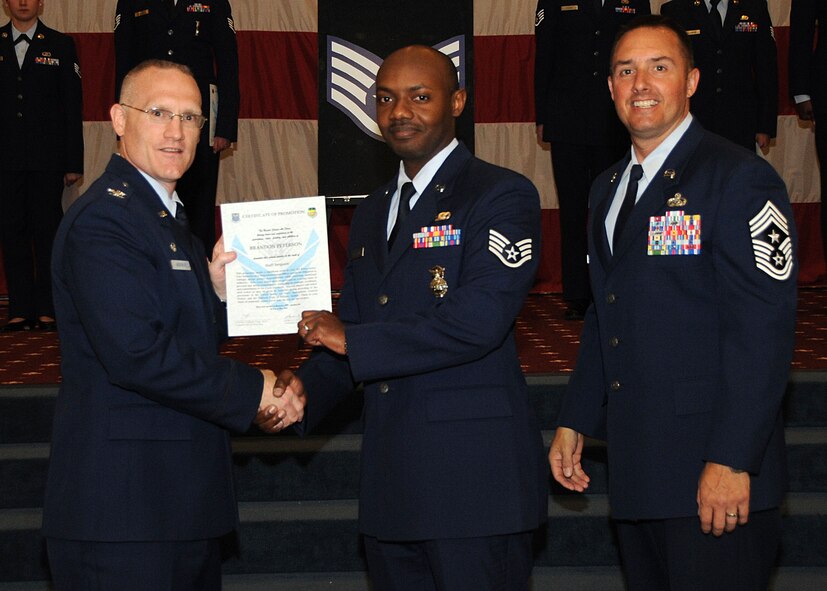 Staff Sgt. Brandon Peterson, 2nd Security Forces Squadron, receives a certificate of promotion from Col. Michael Adderley, 2nd Operations Group commander, and Chief Master Sgt. Curtis Storms, 2nd Bomb Wing command chief, during the Wing Promotion Ceremony on Barksdale Air Force Base, La., April 30, 2014. (U.S. Air Force photo/Senior Airman Kristin High)