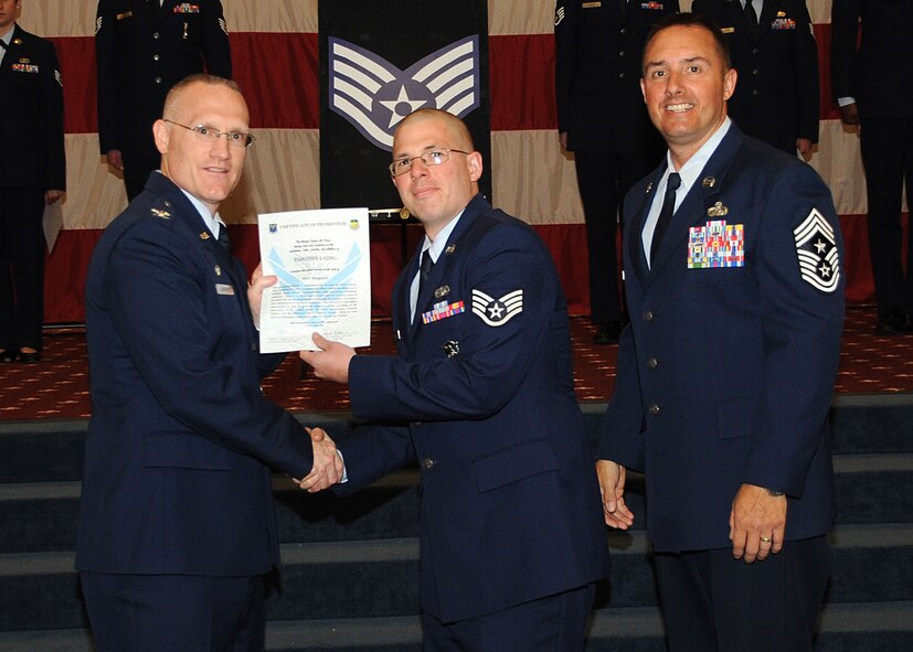 Staff Sgt. Timothy Laing, 2nd Security Forces Squadron, receives a certificate of promotion from Col. Michael Adderley, 2nd Operations Group commander, and Chief Master Sgt. Curtis Storms, 2nd Bomb Wing command chief, during the Wing Promotion Ceremony on Barksdale Air Force Base, La., April 30, 2014. (U.S. Air Force photo/Senior Airman Kristin High)