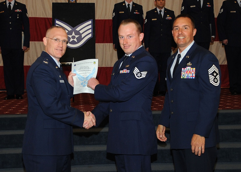 Staff Sgt. Nicholas Gribble, 2nd Security Forces Squadron, receives a certificate of promotion from Col. Michael Adderley, 2nd Operations Group commander, and Chief Master Sgt. Curtis Storms, 2nd Bomb Wing command chief, during the Wing Promotion Ceremony on Barksdale Air Force Base, La., April 30, 2014. (U.S. Air Force photo/Senior Airman Kristin High)