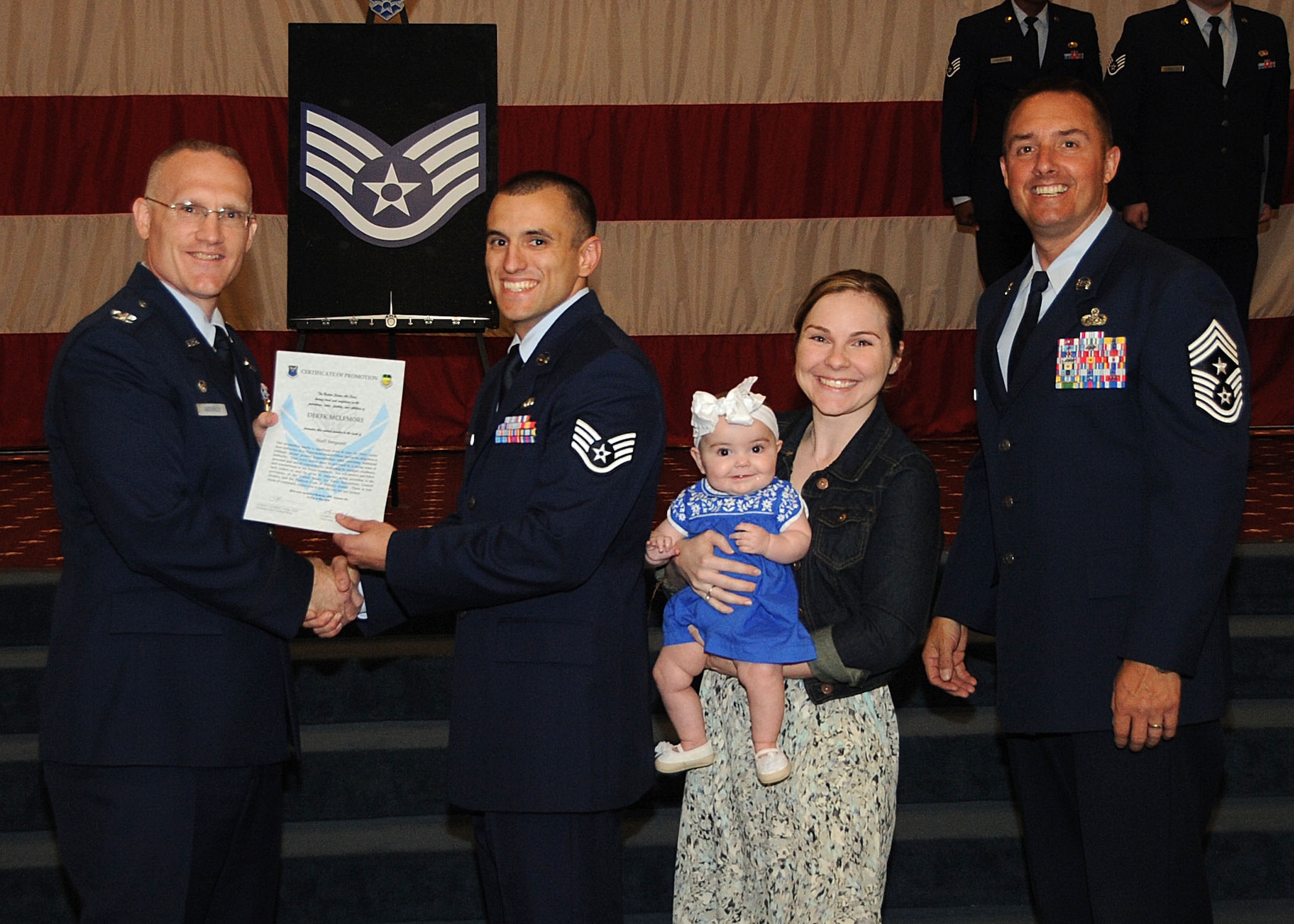 Staff Sgt. Derek Mclemore, 2nd Logistics Readiness Squadron, receives a certificate of promotion from Col. Michael Adderley, 2nd Operations Group commander, and Chief Master Sgt. Curtis Storms, 2nd Bomb Wing command chief, during the Wing Promotion Ceremony on Barksdale Air Force Base, La., April 30, 2014. (U.S. Air Force photo/Senior Airman Kristin High)