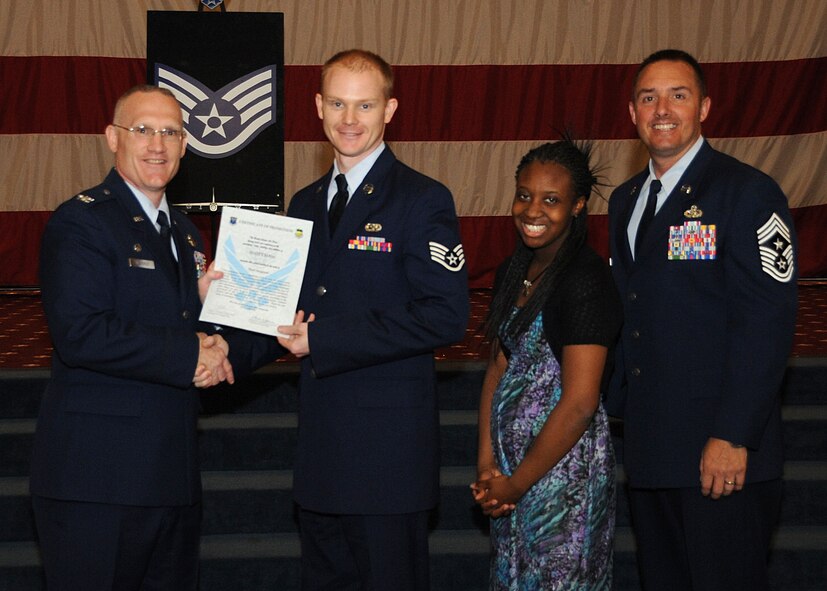 Staff Sgt. Scott Foss, 2nd Aircraft Maintanence Squadron, receives a certificate of promotion from Col. Michael Adderley, 2nd Operations Group commander, and Chief Master Sgt. Curtis Storms, 2nd Bomb Wing command chief, during the Wing Promotion Ceremony on Barksdale Air Force Base, La., April 30, 2014. (U.S. Air Force photo/Senior Airman Kristin High)