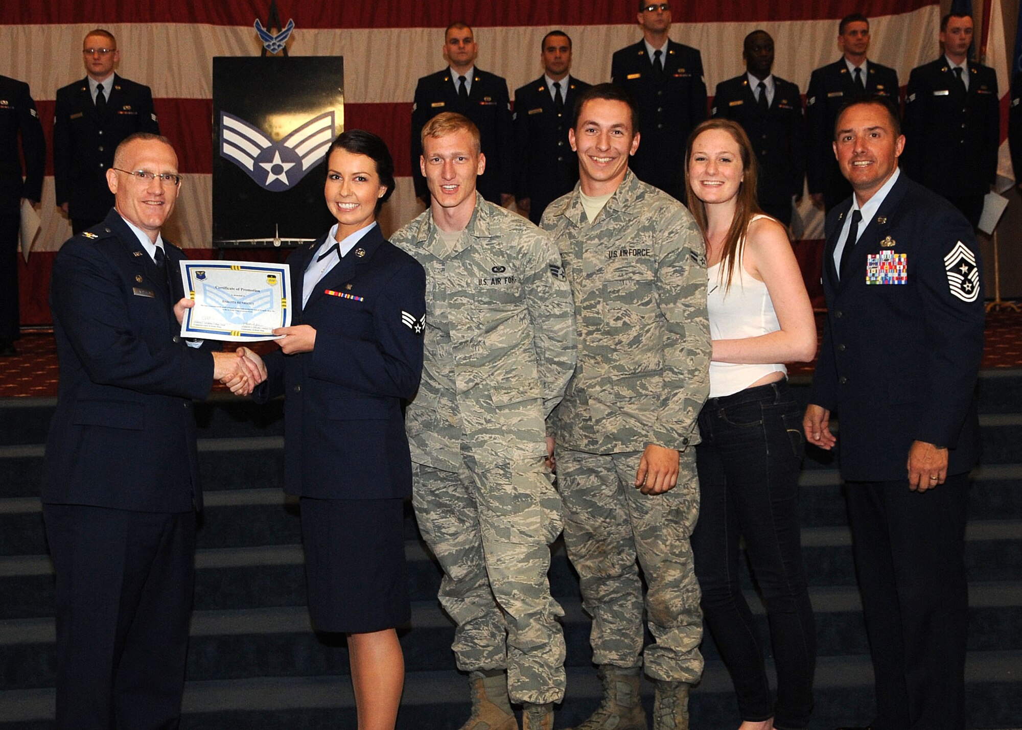 Senior Airman Dakota Henriott, 2nd Medical Support Squadron, receives a certificate of promotion from Col. Michael Adderley, 2nd Operations Group commander, and Chief Master Sgt. Curtis Storms, 2nd Bomb Wing command chief, during the Wing Promotion Ceremony on Barksdale Air Force Base, La., April 30, 2014. (U.S. Air Force photo/Senior Airman Kristin High)