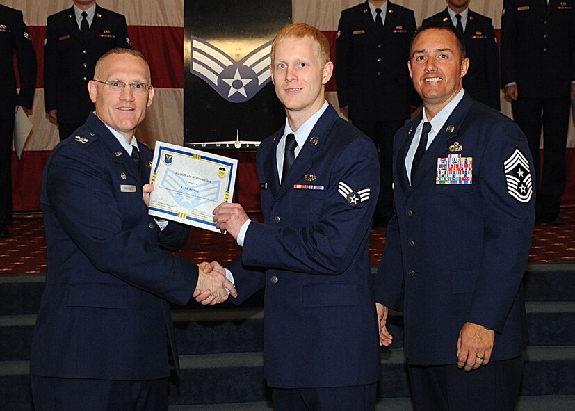 Senior Airman Kyle Runge, 2nd Maintenance Squadron, receives a certificate of promotion from Col. Michael Adderley, 2nd Operations Group commander, and Chief Master Sgt. Curtis Storms, 2nd Bomb Wing command chief, during the Wing Promotion Ceremony on Barksdale Air Force Base, La., April 30, 2014. (U.S. Air Force photo/Senior Airman Kristin High)