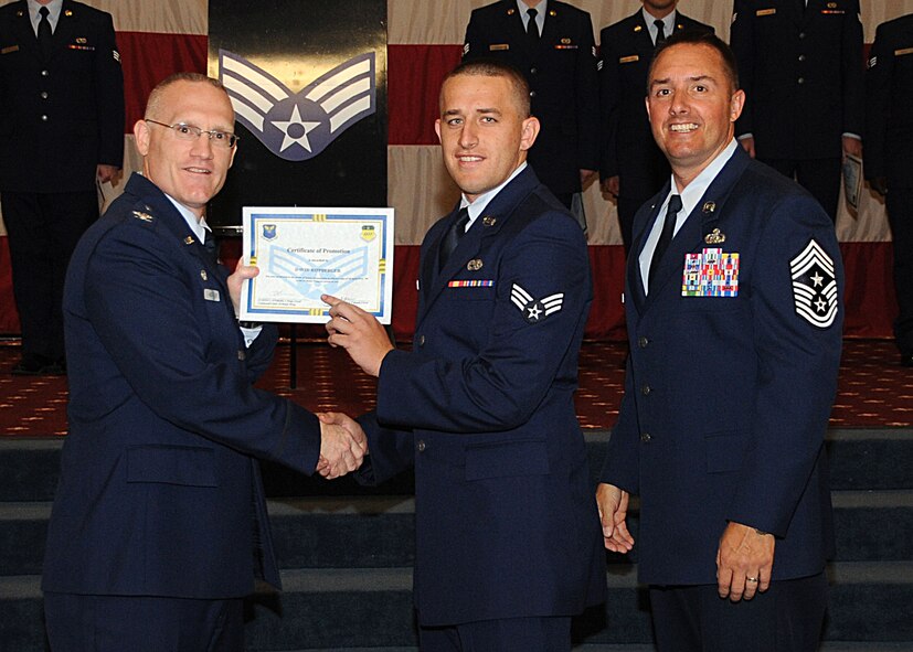 Senior Airman David Rippberger, 2nd Maintenance Squadron, receives a certificate of promotion from Col. Michael Adderley, 2nd Operations Group commander, and Chief Master Sgt. Curtis Storms, 2nd Bomb Wing command chief, during the Wing Promotion Ceremony on Barksdale Air Force Base, La., April 30, 2014. (U.S. Air Force photo/Senior Airman Kristin High)