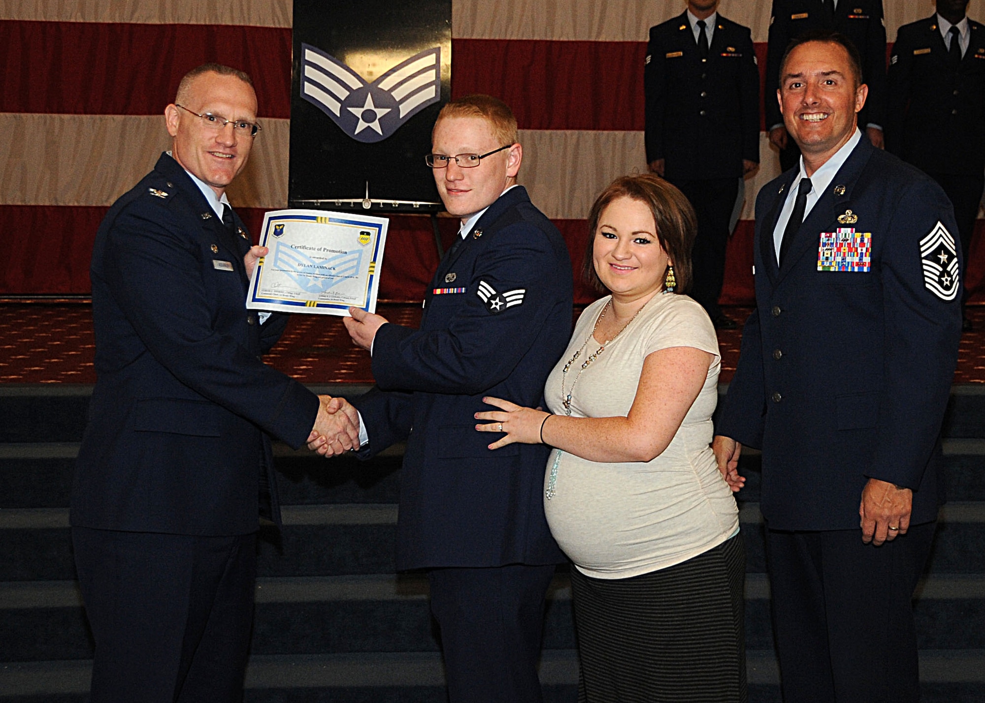Senior Airman Dylan Laminack, 2nd Maintenance Squadron, receives a certificate of promotion from Col. Michael Adderley, 2nd Operations Group commander, and Chief Master Sgt. Curtis Storms, 2nd Bomb Wing command chief, during the Wing Promotion Ceremony on Barksdale Air Force Base, La., April 30, 2014. (U.S. Air Force photo/Senior Airman Kristin High)