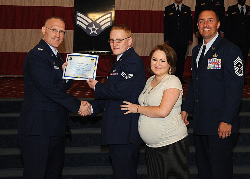 Senior Airman Dylan Laminack, 2nd Maintenance Squadron, receives a certificate of promotion from Col. Michael Adderley, 2nd Operations Group commander, and Chief Master Sgt. Curtis Storms, 2nd Bomb Wing command chief, during the Wing Promotion Ceremony on Barksdale Air Force Base, La., April 30, 2014. (U.S. Air Force photo/Senior Airman Kristin High)