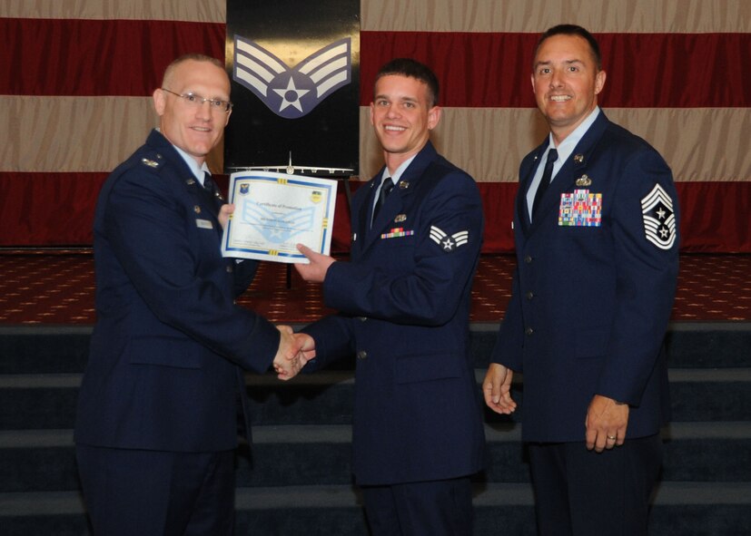 Senior Airman Brandon Sangston, 2nd Aircraft Maintenance Squadron, receives a certificate of promotion from Col. Michael Adderley, 2nd Operations Group commander, and Chief Master Sgt. Curtis Storms, 2nd Bomb Wing command chief, during the Wing Promotion Ceremony on Barksdale Air Force Base, La., April 30, 2014. (U.S. Air Force photo/Senior Airman Kristin High)