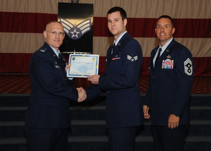 Senior Airman Vincent Barrington, 2nd Aircraft Maintenance Squadron, receives a certificate of promotion from Col. Michael Adderley, 2nd Operations Group commander, and Chief Master Sgt. Curtis Storms, 2nd Bomb Wing command chief, during the Wing Promotion Ceremony on Barksdale Air Force Base, La., April 30, 2014. (U.S. Air Force photo/Senior Airman Kristin High)