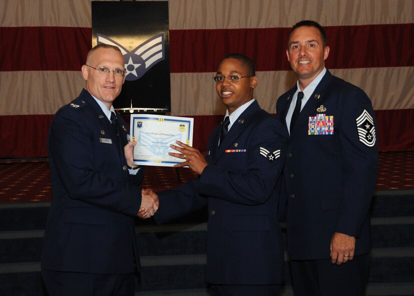 Senior Airman Jeremy Sayles, 2nd Aerospace Medicine Squadron, receives a certificate of promotion from Col. Michael Adderley, 2nd Operations Group commander, and Chief Master Sgt. Curtis Storms, 2nd Bomb Wing command chief, during the Wing Promotion Ceremony on Barksdale Air Force Base, La., April 30, 2014. (U.S. Air Force photo/Senior Airman Kristin High)