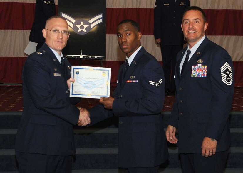 Airman 1st Class Randall Collier, 26th Operational Weather Squadron, receives a certificate of promotion from Col. Michael Adderley, 2nd Operations Group commander, and Chief Master Sgt. Curtis Storms, 2nd Bomb Wing command chief, during the Wing Promotion Ceremony on Barksdale Air Force Base, La., April 30, 2014. (U.S. Air Force photo/Senior Airman Kristin High)