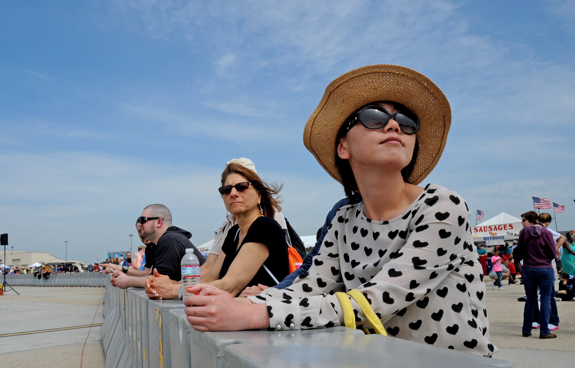 Visitors gather at the center stage barrier to watch aerial performances at the Open House and Air Show May 10, 2014, at Joint Base McGuire-Dix-Lakehurst, N.J. The Open House and Air Show provided more than 300,000 visitors an opportunity to learn more about America's only tri-service joint base, which included demonstrations and static displays of aircraft and vehicles from all five services and various civilian agencies throughout the two-day event.  (U.S. Air Force photo by Airman 1st Class Sean M. Crowe/Released)