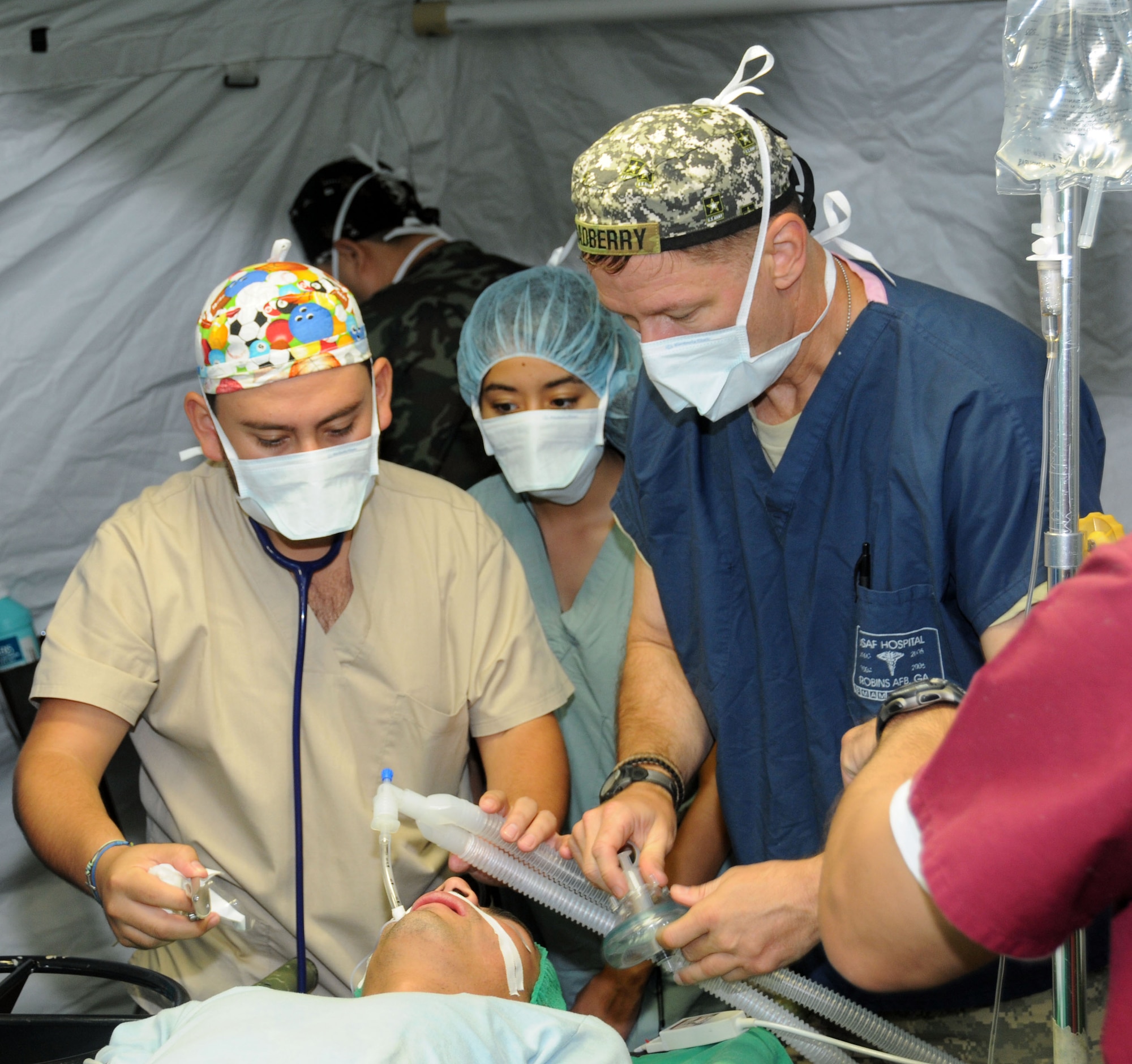 U. S. Army Maj. Scott Gadberry and a Honduran surgical staff member administers anesthetics to a Honduran man before his gall bladder surgery May 7.  His case is one of eight surgeries performed by the Joint Task Force-Bravo's Mobile Surgical Team and the surgical staff of the Santa Rosa hospital in the city of Santa Rosa de Copan, Department of Copan, Honduras during a Medical Readiness Training Exercise May 5-9.  These surgeries, which are often very expensive for Honduran nationals, were provided free of charge.  The work of the MST helped support Honduran medical capabilities while continuing to strengthen the relationship between JTF-Bravo and its partner nation.  (Photo by U. S. Air National Guard Capt. Steven Stubbs)