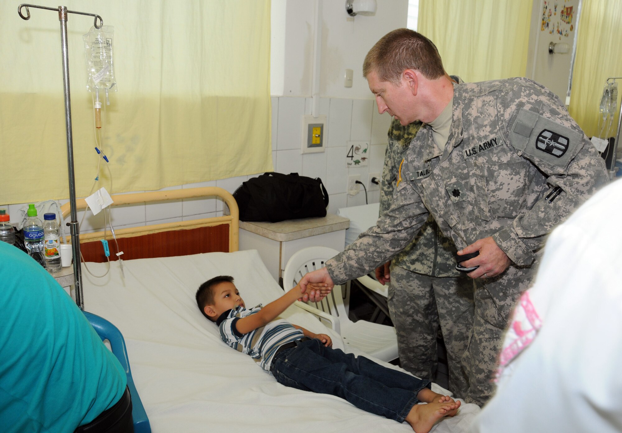 U. S. Army Lt. Col. Mark Talbert greets a five-year-old Honduran boy during a pre-operative visit May 6.  His case is one of eight surgeries performed by the Joint Task Force-Bravo's Mobile Surgical Team and the surgical staff of the Santa Rosa hospital in the city of Santa Rosa de Copan, Department of Copan, Honduras during a Medical Readiness Training Exercise May 5-9.  These surgeries, which are often very expensive for Honduran nationals, were provided free of charge.  The work of the MST helped support Honduran medical capabilities while continuing to strengthen the relationship between JTF-Bravo and its partner nation.  (Photo by U. S Air National Guard Capt. Steven Stubbs)