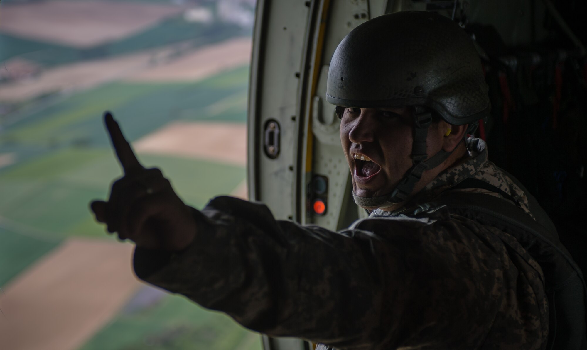 Army Staff Sgt. Alexander Munoz-Lamos, Special Operations Command Africa air NCO, a Fayetteville, North Carolina resident, informs paratroopers inside a C-130J Super Hercules the estimated time to target as part of International Jump Week over Germany, May 6, 2014. A total of 97 foreign and allied partners tested, built and strengthened partnerships during jump week alongside American Airmen and Soldiers. (U.S. Air Force photo/Airman 1st Class Jordan Castelan)