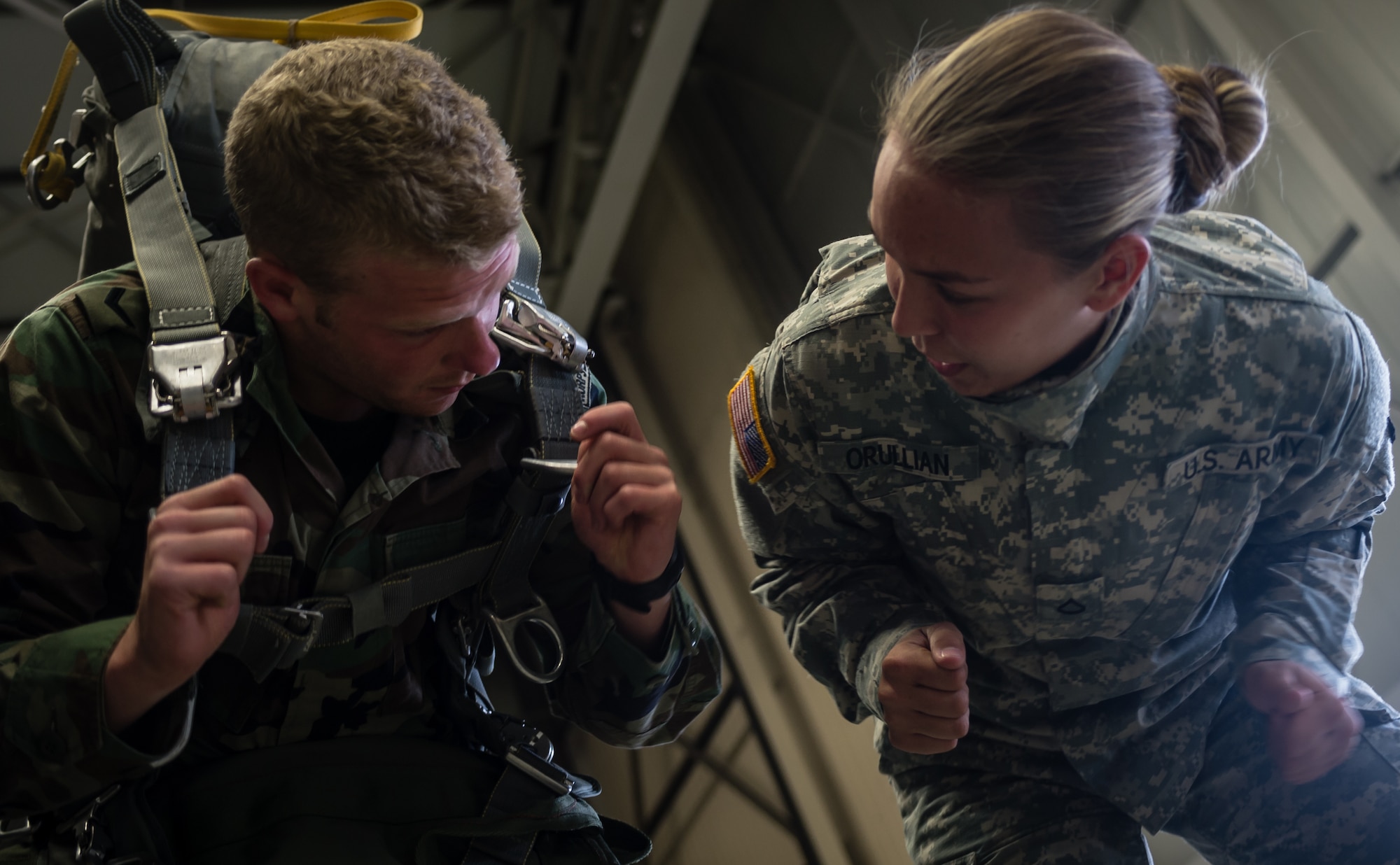 Army Pfc. Kelly Orullian, 5th Quartermaster Aerial Delivery parachute rigger, helps prepare (Korps Mariniers) Royal Netherlands Navy, 1st Class Marine Roy Mave, 11th Raiding Squadron before boarding a C-130J Super Hercules as part of International Jump Week on Ramstein Air Base, Germany, May 6, 2014. A total of 97 foreign and allied partners tested, built and strengthened partnerships during jump week alongside American Airmen and Soldiers. (U.S. Air Force photo/Airman 1st Class Jordan Castelan)