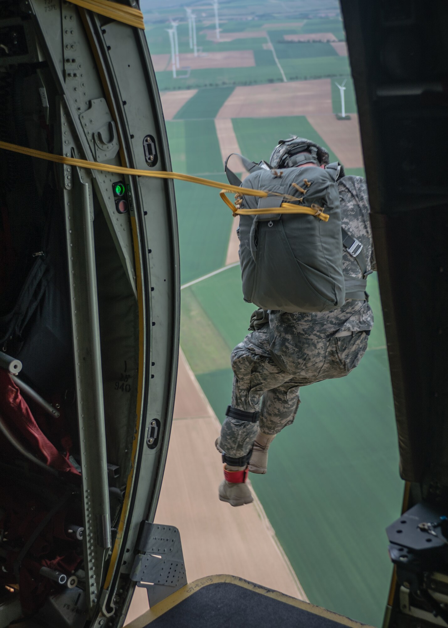Army Sgt. Jordan Markel Witz, 5th Quartermaster Theater Aerial Delivery Company jumpmaster, exits a C-130J Super Hercules as part of International Jump Week over Germany, May 6, 2014. A total of 97 foreign and allied partners tested, built and strengthened partnerships during jump week alongside American Airmen and Soldiers. (U.S. Air Force photo/Airman 1st Class Jordan Castelan)
