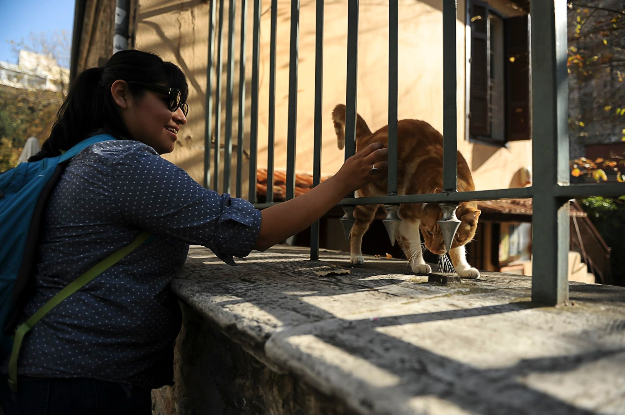 Cecelia Guadalupe Ortiz-Barreiro pets a cat outside of a church Nov. 16, 2013, in Thessaloniki, Greece. Two years removed from a nervous breakdown, Cece credits family support with her recovery and perseverance. (Courtesy photo/Jake Barreiro)  