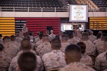 Lt. Col. Jesse Kemp, the commanding officer of 2nd Supply Battalion, 2nd Marine Logistics Group, unveils his battalion's new logo during a ceremony at Camp Lejeune, N.C., May 6, 2014. The new logo linked the battalion to the unique legacy of the Montford Point Marines, who helped break down the walls of racism within the military during World War II.