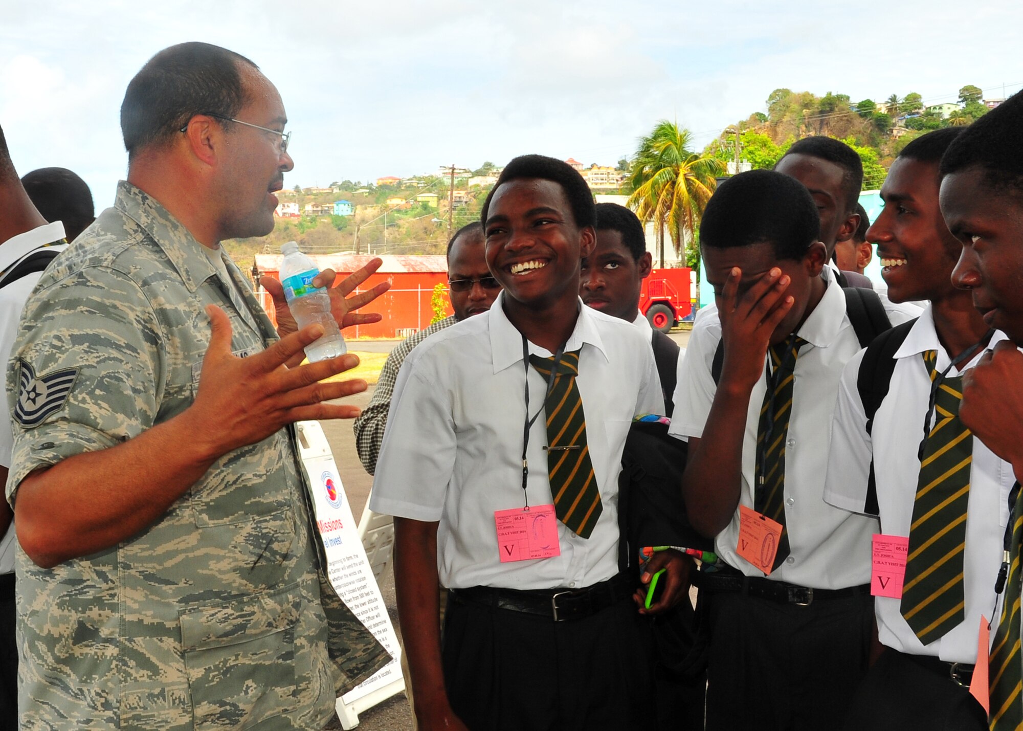 Tech. Sgt. Clinton Nicholas answers student's questions during a tour of the WC-130J Hercules May 9, 2014, at the E.T. Joshua Airport, St. Vincent. Nicholas was part of the Caribbean hurricane awareness tour, or CHAT, May 4-11. CHAT is a joint effort between the National Oceanic and Atmospheric Administration's national hurricane center and the 403rd Wing's 53rd Weather Reconnaissance Squadron. The tour promotes hurricane awareness and preparedness throughout the Caribbean region. Nicholas is a 403rd Aircraft Maintenance Squadron dedicated crew chief. (U.S. Air Force photo/Maj. Marnee A.C.Losurdo)