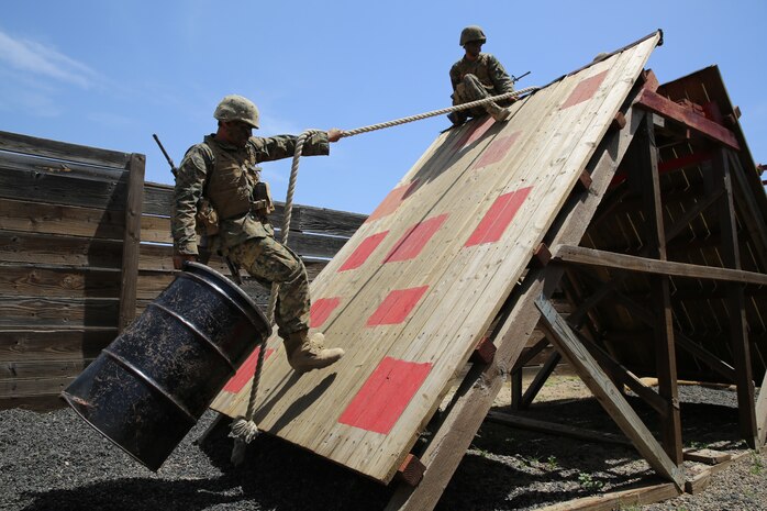 Company A Marines, 1st Recruit Training Battalion, transport a barrel from one side of an obstacle to the other using only a rope in stall 11 at the Leadership Reaction Course during the Crucible at Edson Range, April 30. If Marines touched the red squares, the were consider a casualty and had to run 100 yards with 30 pound ammunition cans. Once they were finished with that, they returned to the stall to attempt the mission again.