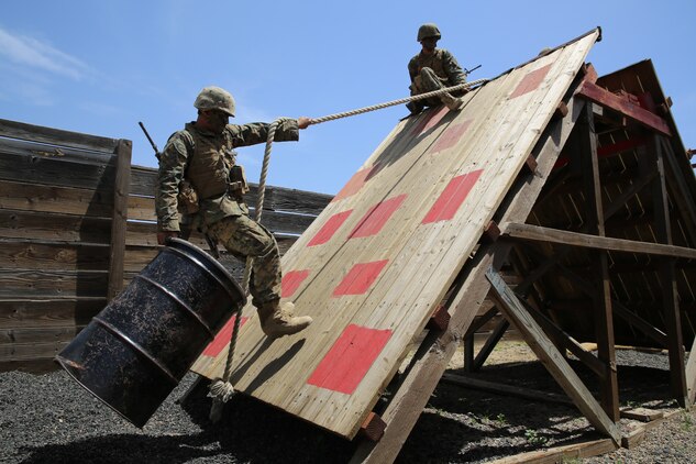 Company A Marines, 1st Recruit Training Battalion, transport a barrel from one side of an obstacle to the other using only a rope in stall 11 at the Leadership Reaction Course during the Crucible at Edson Range, April 30. If Marines touched the red squares, the were consider a casualty and had to run 100 yards with 30 pound ammunition cans. Once they were finished with that, they returned to the stall to attempt the mission again.