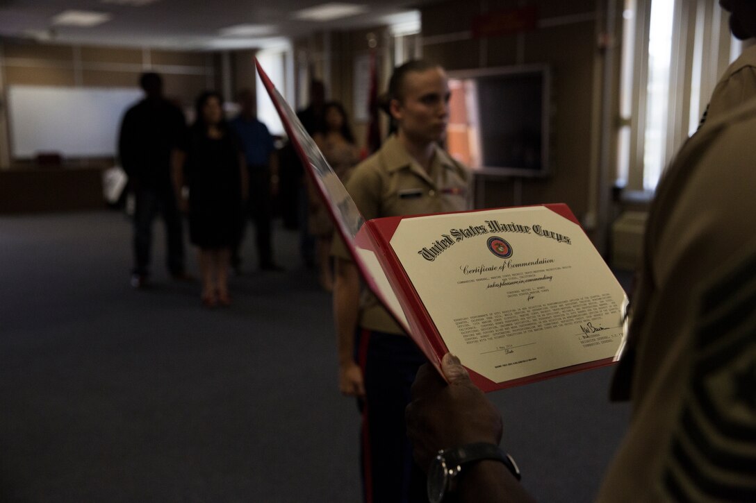 Cpl. Britny L. Brown, 12th Marine Corps District Headquarters, separations chief, receives a certificate of commendation from Brig. Gen. James W. Bierman, commanding general of Marine Corps Recruit Depot (MCRD) San Diego and Western Recruiting Region, for her outstanding performance as a non-commissioned officer (NCO) of Marines.  Brown was recently announced NCO of the Quarter for MCRD San Diego for her distinguished leadership amongst her fellow Marines.