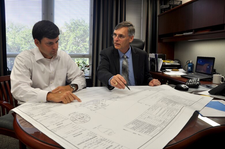 Real Property Exchange manager Stephen Bruce (left) and Real Estate Division Chief Ralph Werthmann review project drawings for Army Reserve property in Orland Park, Illinois. 