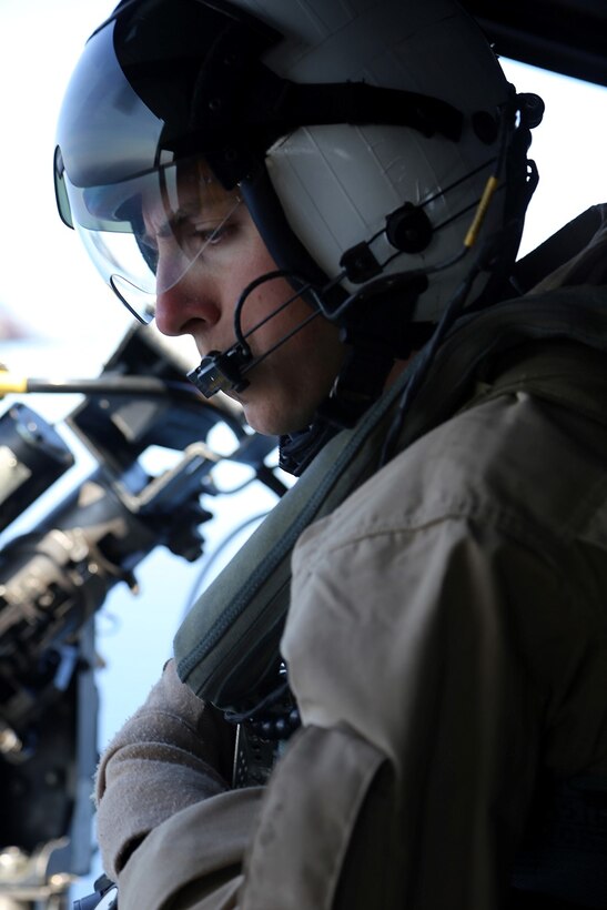 Sgt. Kyle M. Kendall, an aerial observer (in training) with Marine Medium Tiltrotor Squadron 163 (Reinforced), 11th Marine Expeditionary Unit, listens to communication over his headset during a tactical recovery of aircraft and personnel (TRAP) training mission over San Clemente Island, Calif.,  during Composite Training Unit Exercise (COMPTUEX) off the coast of Southern California , May 10, 2014. The 11th MEU and Amphibious Squadron 5 team conduct COMPTUEX to hone mission essential tasks, execute specified MEU and ARG operations, and establish the foundation for a cohesive warfighting team for future exercises and operations. (U.S. Marine Corps photo by Gunnery Sgt. Rome M. Lazarus/Released)