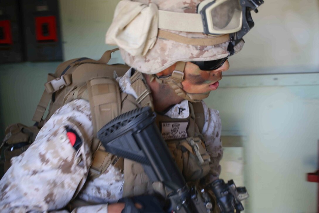 Lance Cpl. Christian Salazarvargas, a rifleman with Golf Company, Battalion Landing Team 2nd Battalion, 1st Marines (BLT 2/1), 11th Marine Expeditionary Unit, clears a building as part of an airfield seizure during Composite Training Unit Exercise, on San Clemente Island, Calif., May 10, 2014. COMPTUEX provides the 11th MEU, along with the Makin Island Amphibious Ready Group, the opportunity to conduct command and control of amphibious operations from the sea. (U.S. Marine Corps photo by Lance Cpl. Evan R. White/RELEASED)