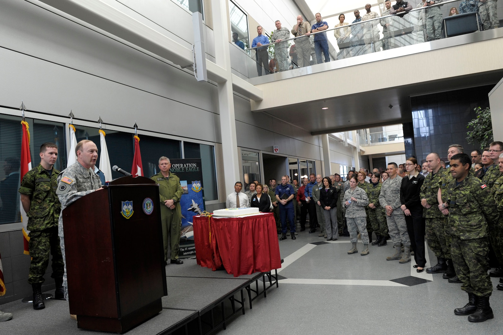 Army Gen. Charles ‘Chuck’ Jacoby, North American Aerospace Defense Command and U.S. Northern Command commander, speaks to a crowd of command members in the atrium of the headquarters building on Peterson Air Force Base, Colo. The crowd gathered to celebrate NORAD’s 56 birthday.  Photo by Air Force Master Sgt. Andy Bellamy/Released.