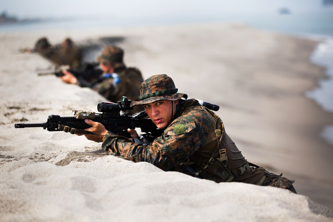 U.S. Marines with 3rd Reconnaissance Battalion conduct a “hasty beach report” during an amphibious landing exercise between the Philippine and the U.S. Marine Corps at the Naval Education Training Center here May 9. The training evolution, as part of Balikatan 2014, aimed at enhancing interoperability and strengthening the Philippine-U.S. relationship.
