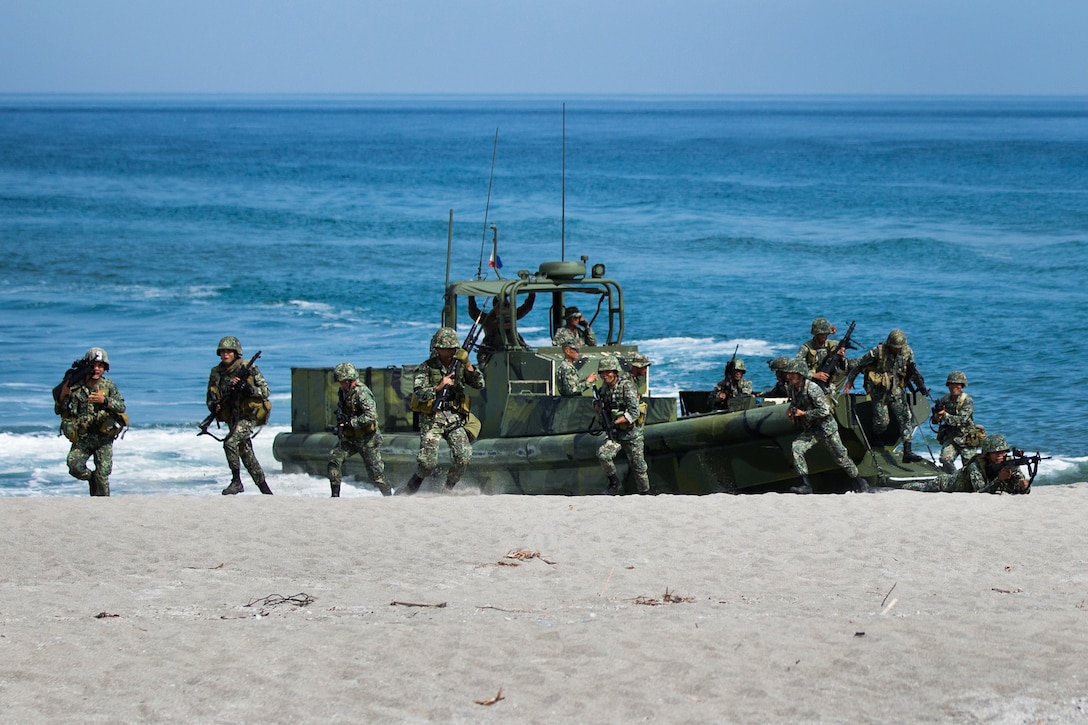 SAN ANTONIO, Philippines – Philippine Marines with Marine Special Operation Platoon 2, Marine Battalion Landing Team 2, storm the beach during an amphibious boat landing exercise with the U.S. Marine Corps at the Naval Education Training Center here May 9. The training evolution, as part of Balikatan 2014, aimed at enhancing interoperability and strengthening the Philippine-U.S. relationship.