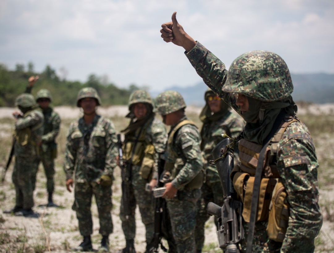 Philippine Marines raise their thumb to signal their weapons are clear after performing squad fire and maneuver training events May 8, 2014, at Crow Valley, Philippines, during Balikatan 2014. The Philippine Marines rushed across a field while U.S. Marines supplied machine gun supporting fire. The bilateral training increased the Philippine and U.S. Marines capabilities for combined operations. Balikatan is an annual training exercise that strengthens the interoperability between the Armed Forces of the Philippines and U.S. military in their commitment to regional security and stability, humanitarian assistance and disaster relief. 


