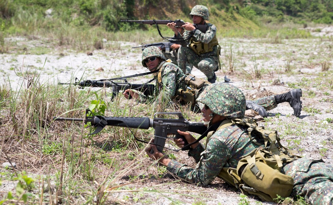 Philippine Marines assigned to 311th Marine Company, 11th Marine Battalion, perform a squad level fire and maneuver technique while their U.S. Marine Corps counterparts supplied suppressive machine gun fire during live-fire exercises May 9, 2014, at Crow Valley, Philippines, for Balikatan 2014. The two nation’s Marines partnered together to increase efficiency and effectiveness in assaulting an enemy position. Balikatan is an annual training exercise that strengthens the interoperability between the Armed Forces of the Philippines and U.S. military in their commitment to regional security and stability, humanitarian assistance and disaster relief.