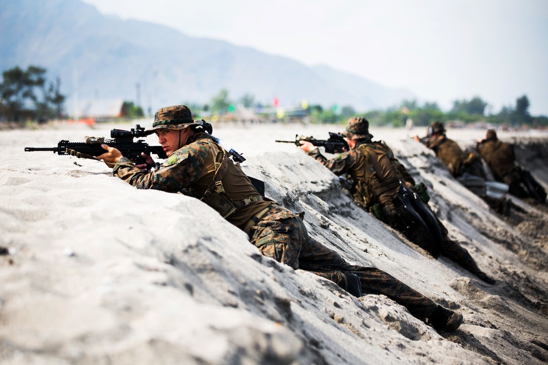 U.S. Marines with 3rd Reconnaissance Battalion conduct a “hasty beach report” during an amphibious landing exercise between the Philippine and the U.S. Marine Corps at the Naval Education Training Center here May 9. The training evolution, as part of Balikatan 2014, aimed at enhancing interoperability and strengthening the Philippine-U.S. relationship.